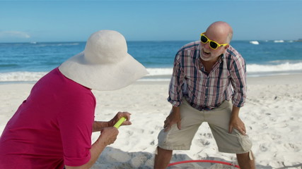 Senior couple doing hula hoop - Powered by Adobe