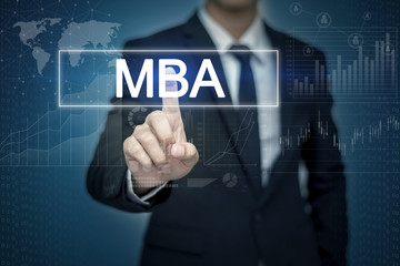 Businessman hand touching MBA button on virtual screen
