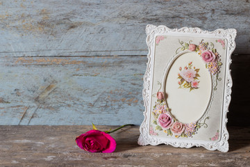 Still life with frame,flowers on rusty background
