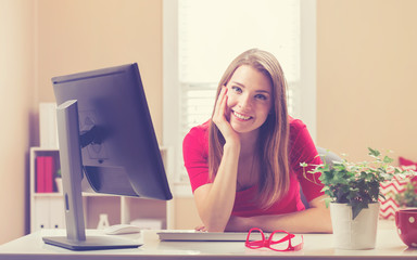 Young woman smiling in her home office