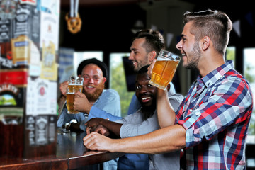 Young men drinking beer in pub