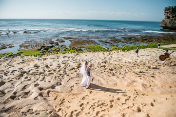the bride and groom go to the beach