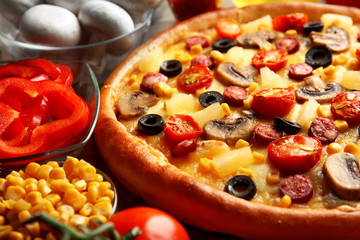 Delicious pizza with vegetables and meat, close-up