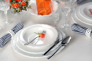 Served table with flowers in restaurant, closeup