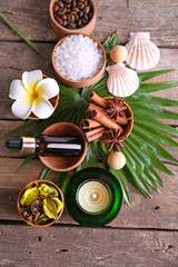 Beautiful spa setting on palm leaf on wooden table