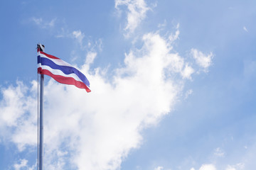 Image of waving Thai flag with blue sky background