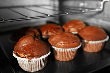 Chocolate cup-cakes in oven, close up