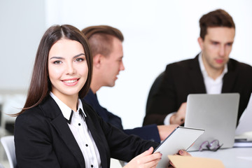 Photo of business woman with her staff in conference room at the meeting