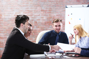 Young business people discussing a new project at the meeting in a conference room