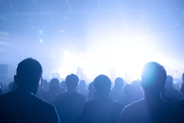 Music concert crowds illuminated from stage lights (very shallow depth of field)