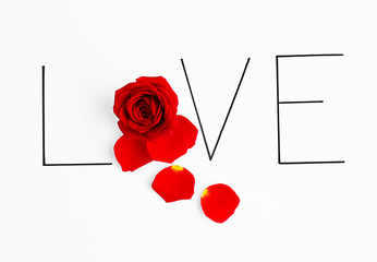 Inscription love with red rose on white background
