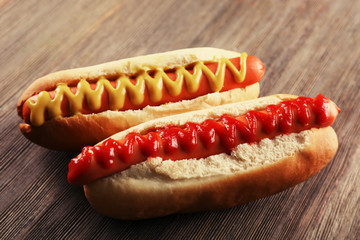 Hot dogs on wooden background, closeup