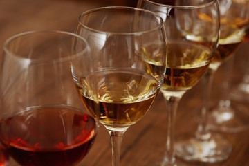 Many glasses of different wine in a row on bar counter, close up