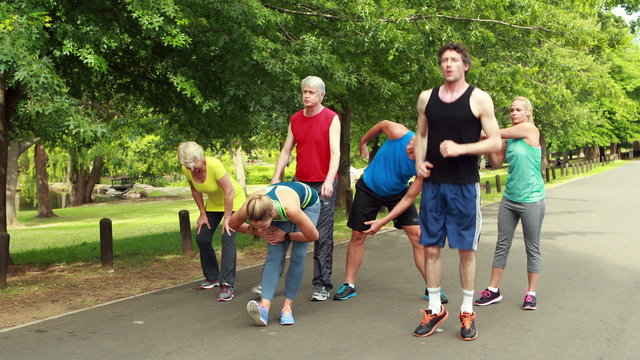 Athletic group stretching and running 