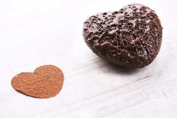 Sweet heart shaped candies on white wooden background