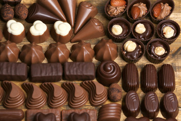 Assortment of delicious chocolate candies background, close up