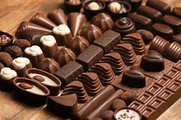 Delicious chocolate candies on wooden background