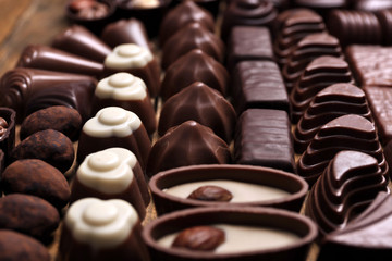 Assortment of delicious chocolate candies background, close up