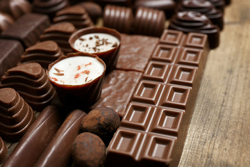 Delicious chocolate candies on wooden background