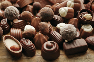 Assortment of delicious chocolate candies background, close up