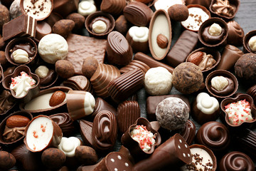 Assortment of delicious chocolate candies background, close up