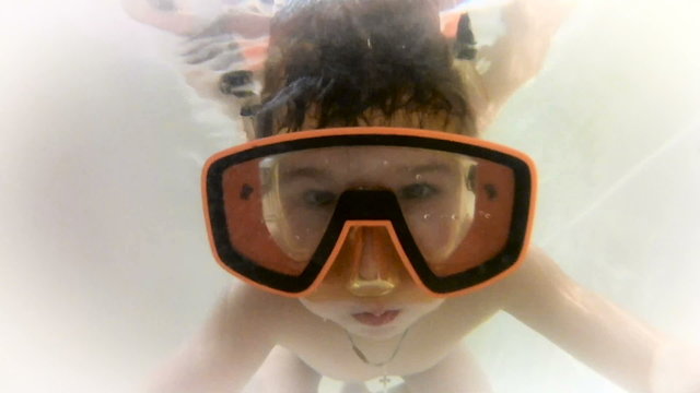 Happy cute little boy underwater