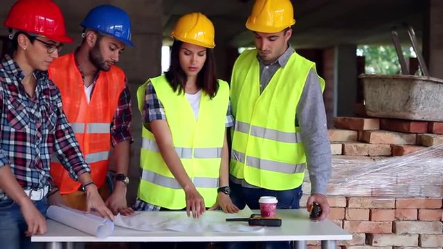 female engineer or architect discussing construction issues with colleagues