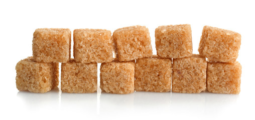 Pile of brown sugar cubes isolated on white background
