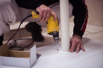 repairman working with drilling machine