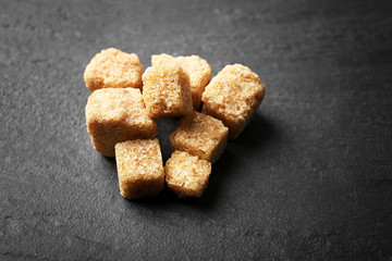 Pile of brown sugar cubes on the table