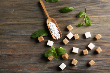 Sugar cubes and stevia  on wooden background