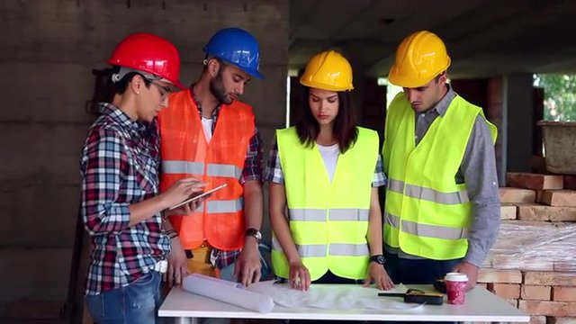 female engineer or architect discussing construction issues with colleagues