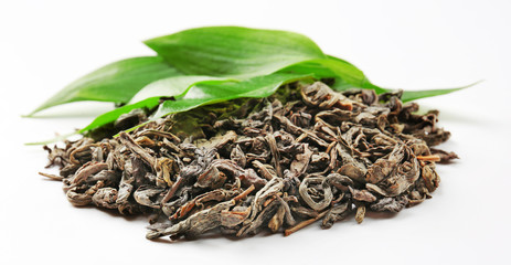 Pile of dry tea with green leaves, isolated on white