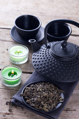 Green tea in bowl and traditional asian tea set