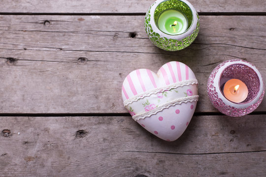 Vintage  decorative  heart and candles in bright lanterns on age