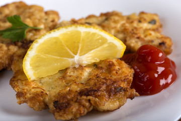Escalope or schnitzel with ketchup or tomato sauce and lemon