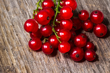Red currants on a wooden table