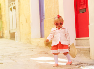 cute little girl walking on the street of Malta