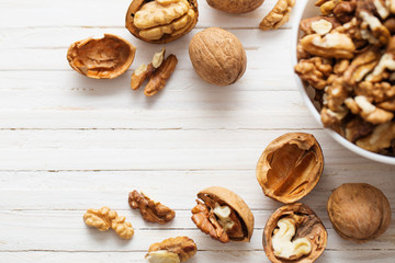  walnuts on white wooden background