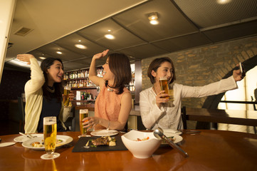 Women are taking a self shot in bar