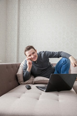 The man on a sofa with laptop