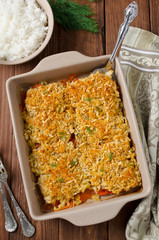 Baked fish fillet with carrots under a bread crust