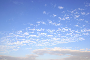 Naklejka na ściany i meble Fantastic soft white clouds against blue sky