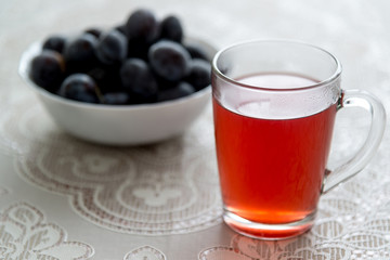 cup of compote and frozen plums on the table