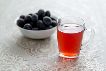  cup of compote and frozen plums on the table