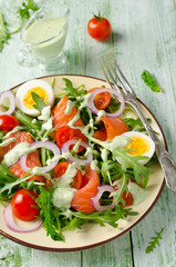 Smoked salmon salad with arugula, tomatoes, eggs and red onion