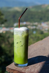 A glass of Green tea smoothies in the organic green tea plantation.