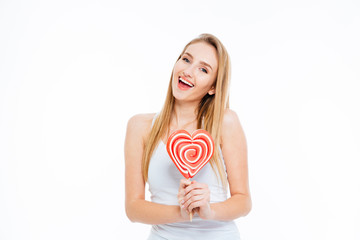 Happy woman holding heart shaped lollipop