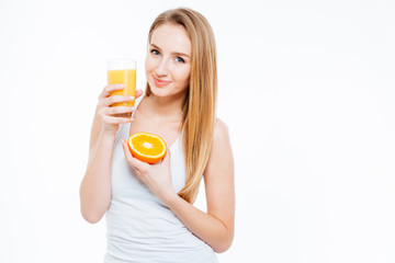 Woman holding orange and glass with fresh juice