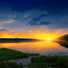 Fototapeta premium orange sunset over river
